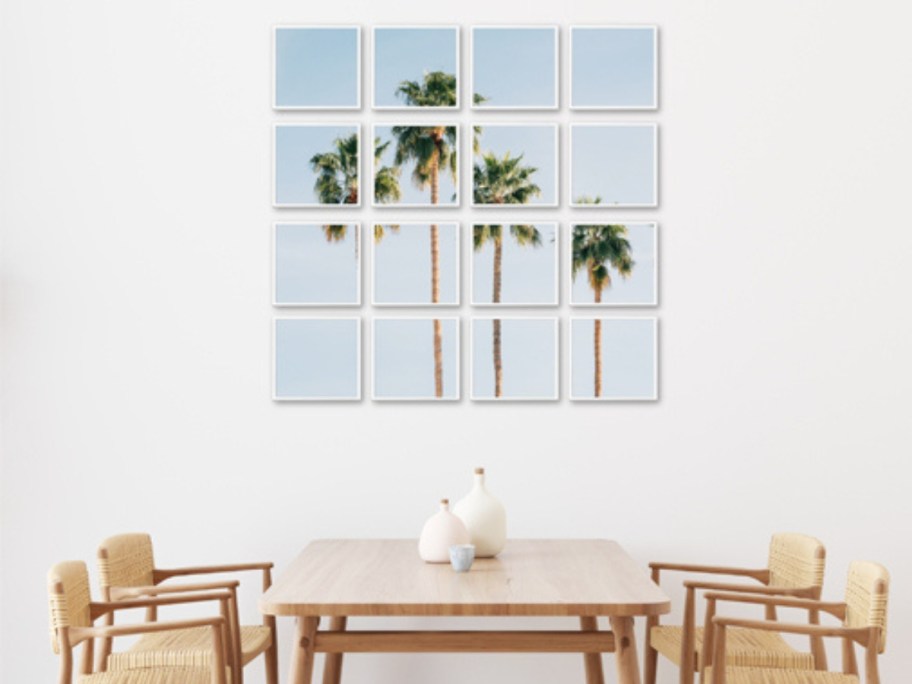 a dining room table with a wall art piece of palm trees and blue skies above it, the image is split into a grid of glass photo frames