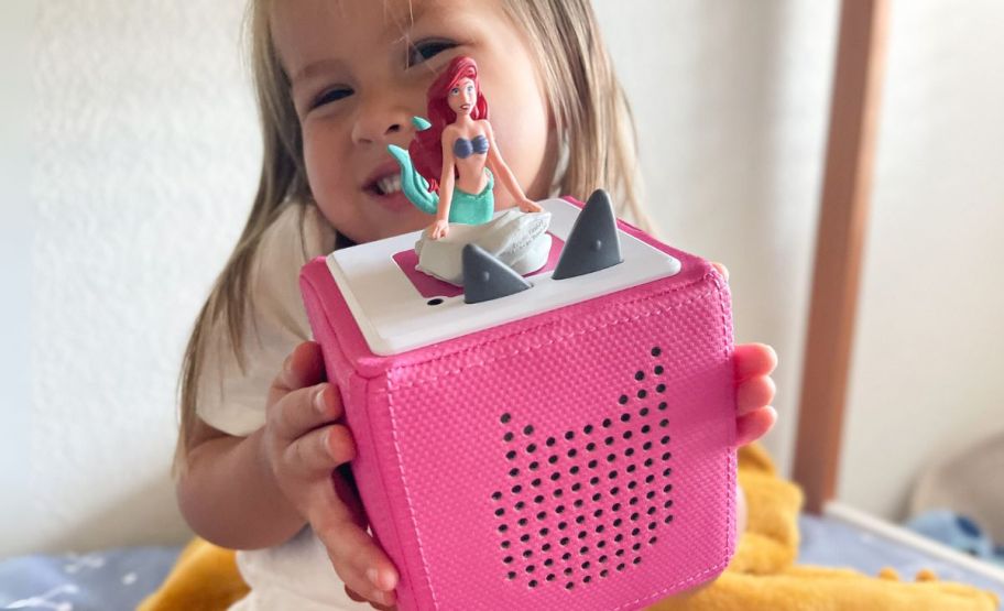 little girl with a tonie box