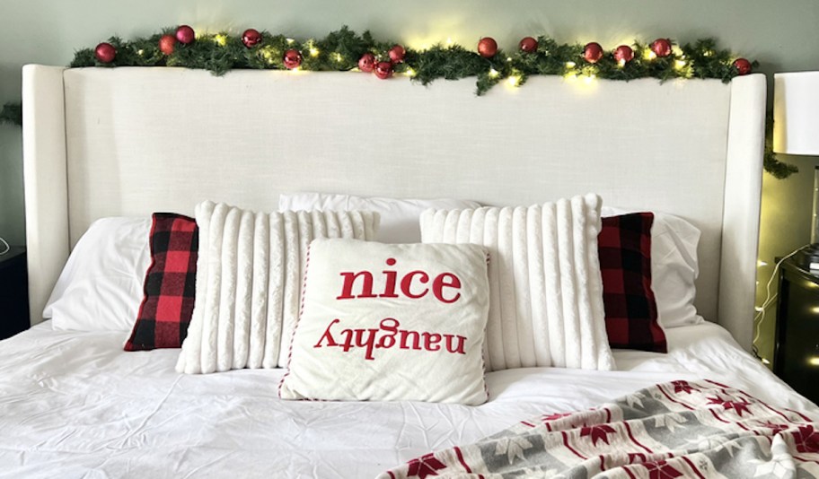 headboard with garland and festive holiday pillows