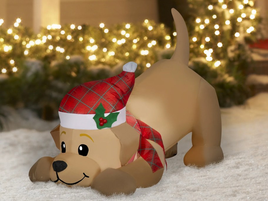 yellow lab inflatable dog in snow filled yard 