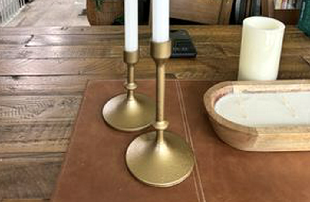 Walmart gold taper candles on table 