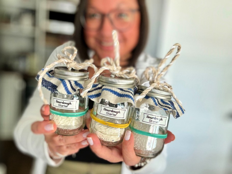 woman holding 3 sourdough starters ways to make extra money