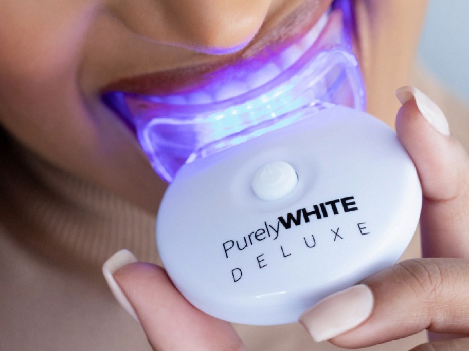 woman holding a PurelyWHITE DELUXE Teeth Whitening Kit