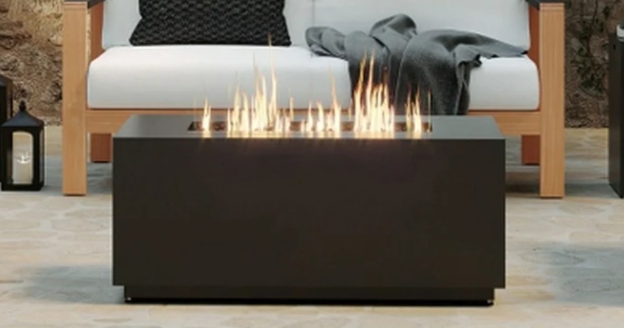 a large rectangle fire pit in an outdoor patio sitting area