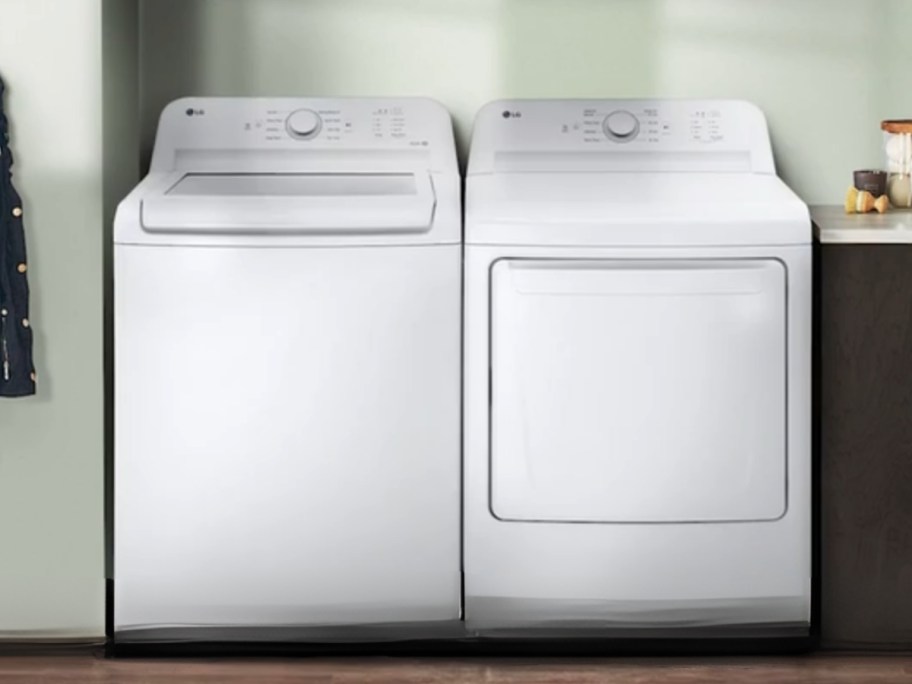 a white top load washing machine and white front load dryer in a laundry room