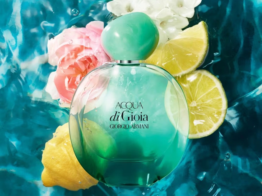 green bottle of Armani Acqua di Gioia Eau de Parfum Intense with lemons and flowers