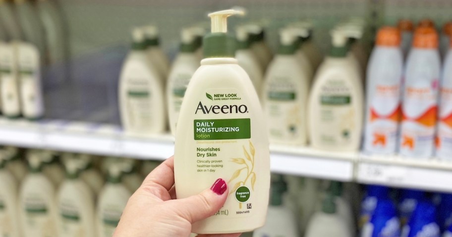 hand holding a bottle of aveeno lotion in store