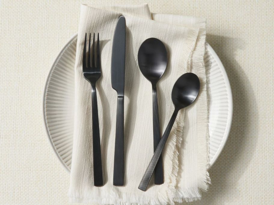 Better Homes & Gardens 42-Piece Stainless Steel Flatware Set in River Black on plate