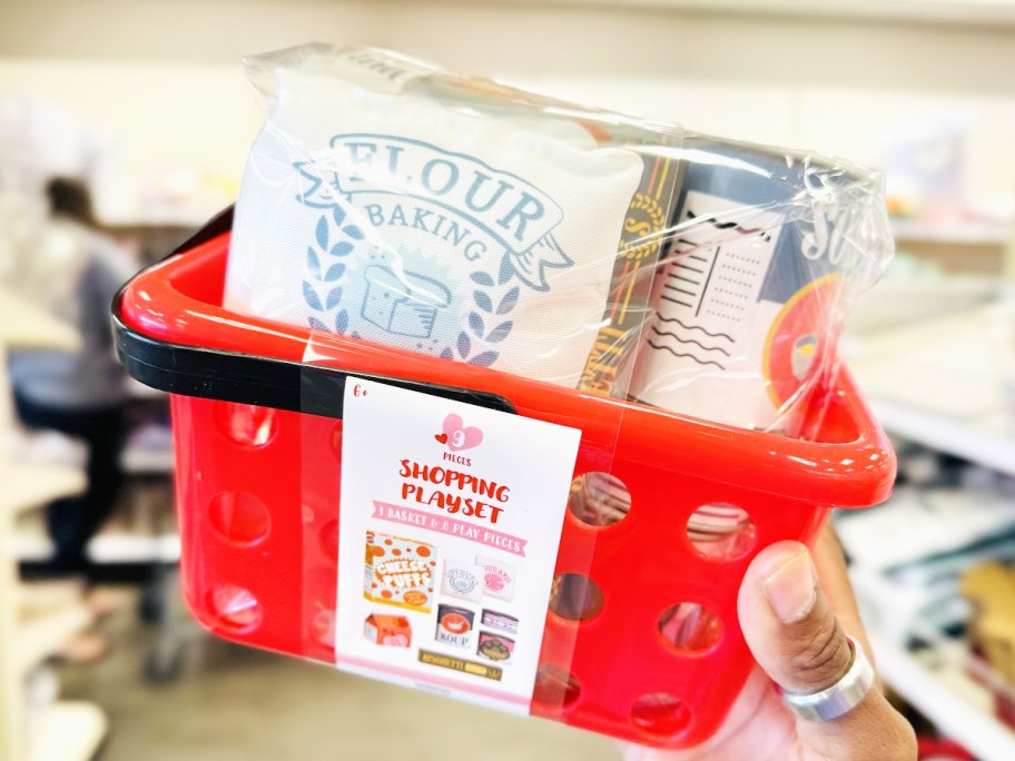 hand holding up a kids mini food basket playset