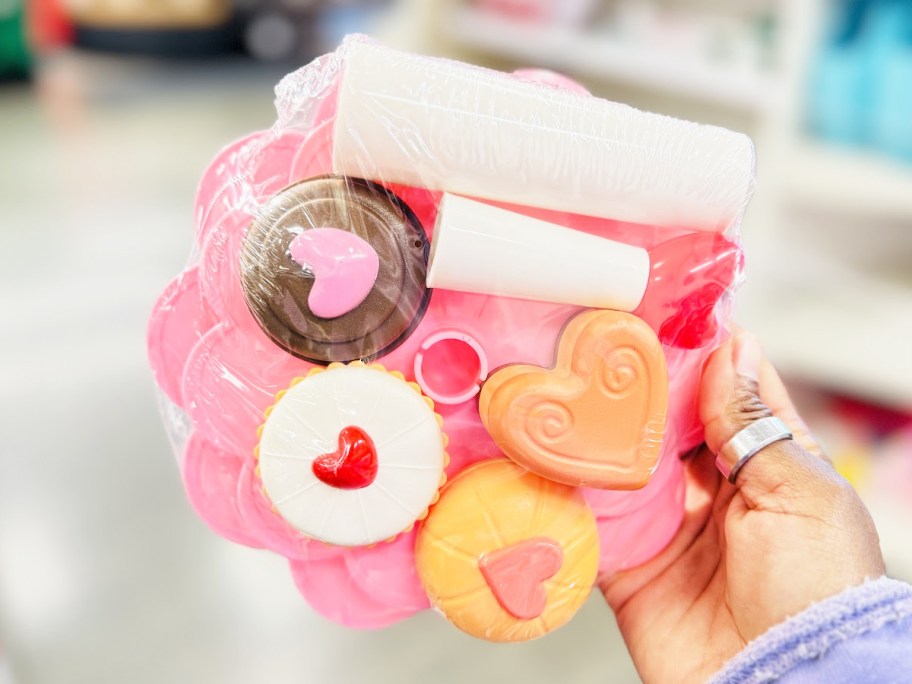 hand holding up a play food serving tray set