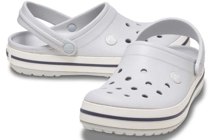 a pair of light gray crocks clogs