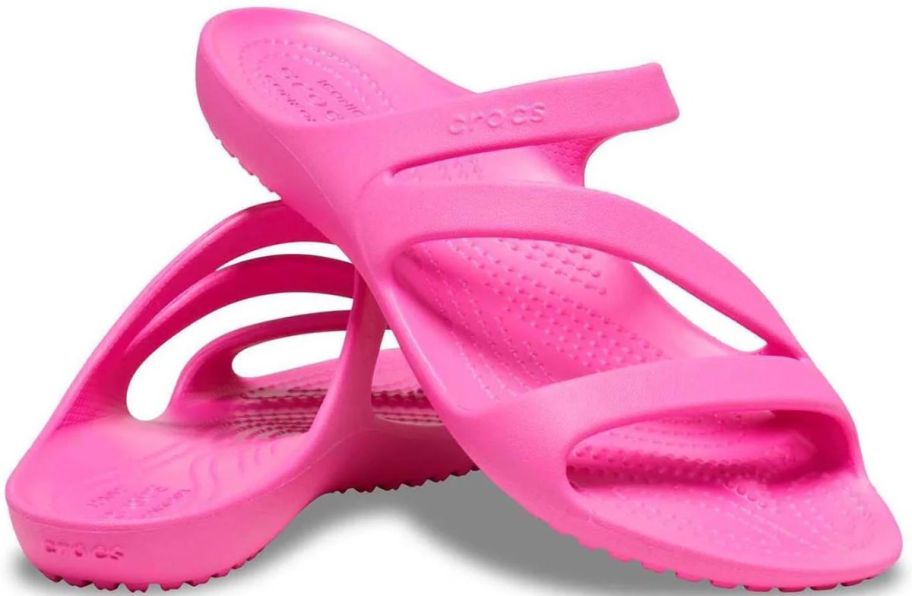 a pair of hot pink crocs strappy sandals