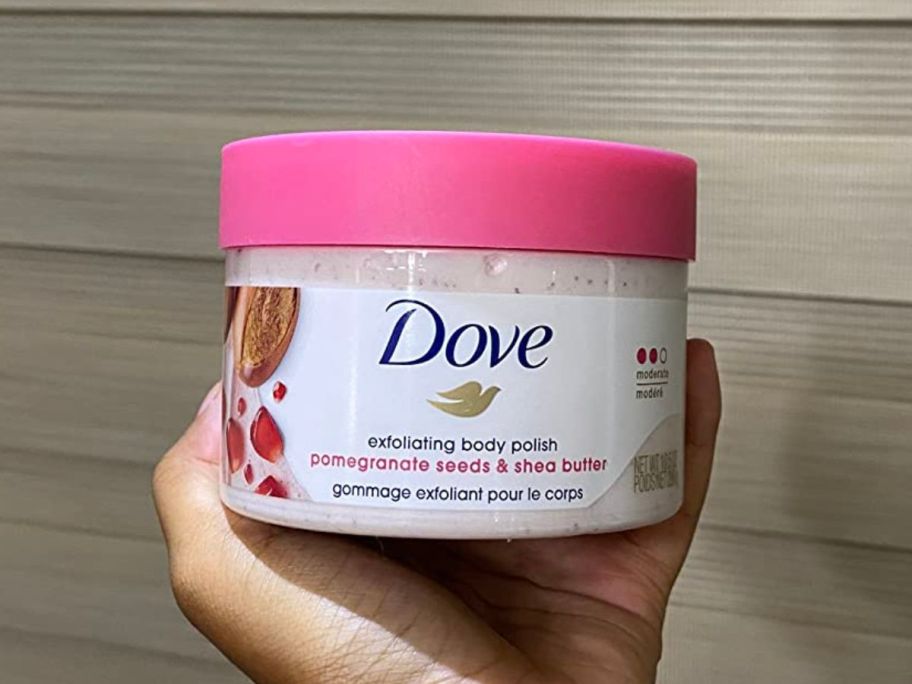 Hand holding up a Dove Body Scrub