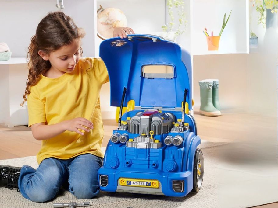 girl playing with Goodyear engine toy