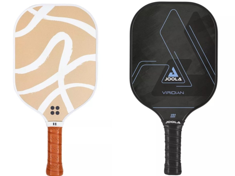 a pickleball paddle with a dark tan handle and light tan and white design on the paddle and another pickleball paddle in black with a light blue design on the paddle