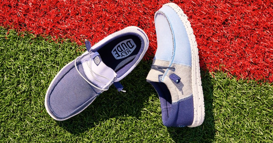 navy blue, grey, and light blue colorblock sneakers on football field