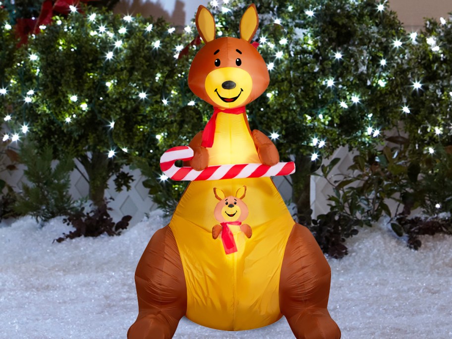 kangaroo holding candy cane inflatable in yard