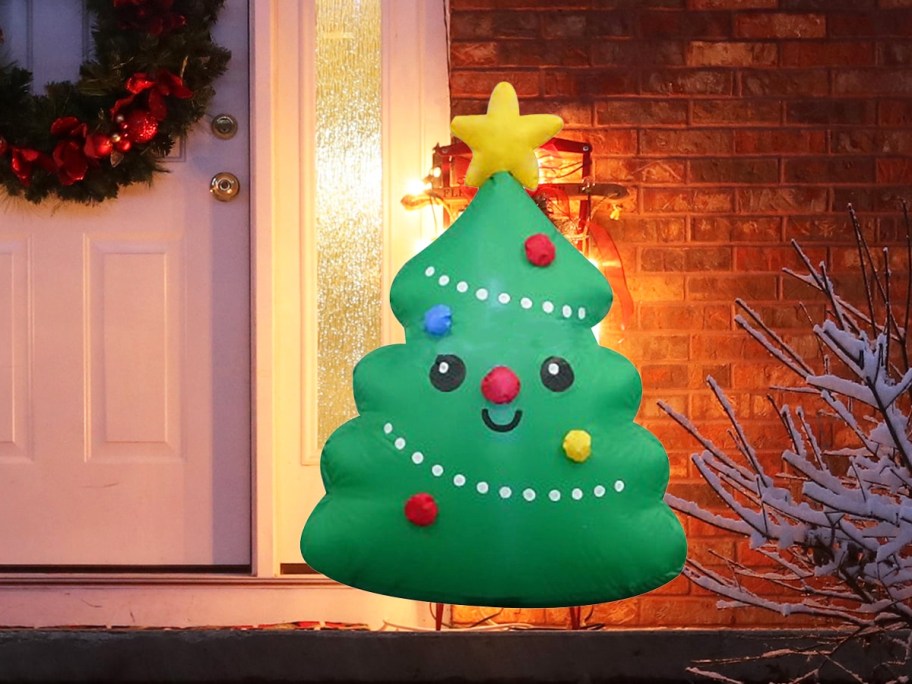 smiling christmas tree inflatable near front door