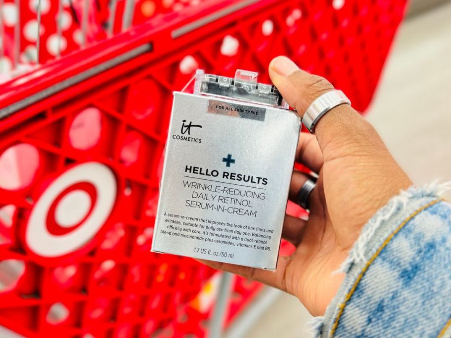 A person holding an IT Cosmetics Hello Results box