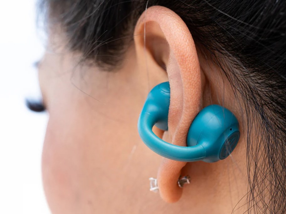 teal open earbud on ear