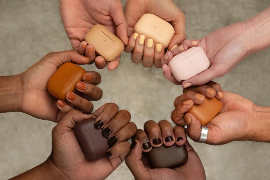 hands holding neutral colored earbuds in a circle