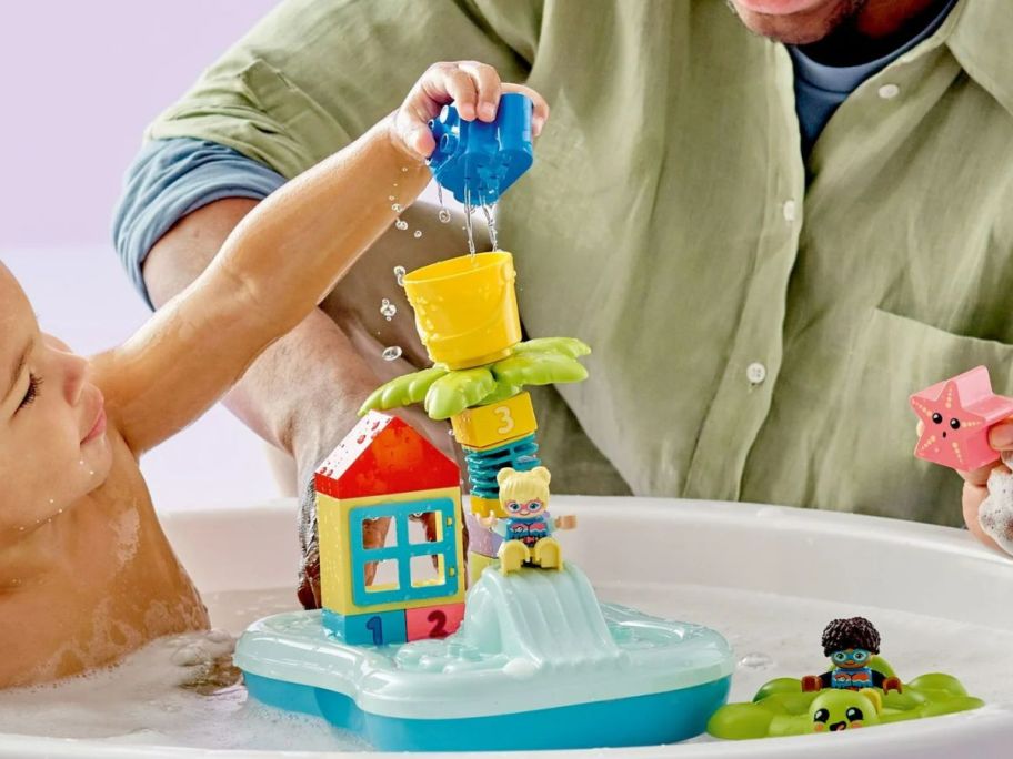 Little boy in a tub playing with a LEGO DUPLO Town Water Park