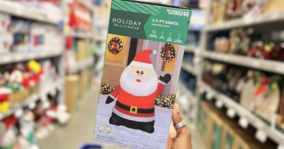 hand holding up box for a santa inflatable in store