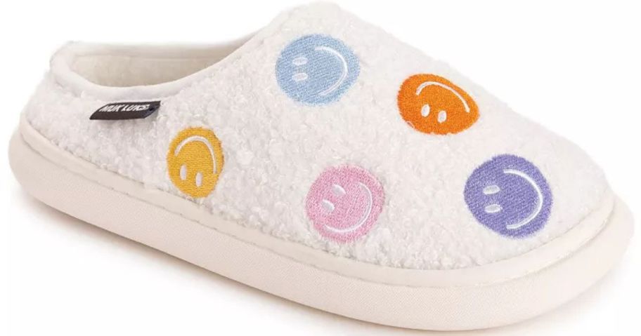 A white slipper with smiling faces on it 