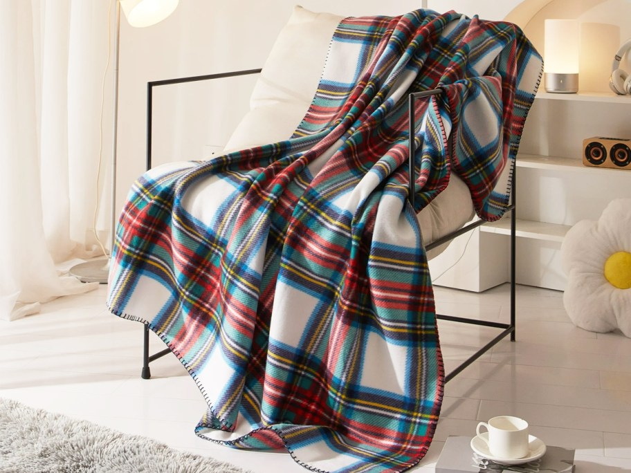 plaid fleece blanket draped over a chair