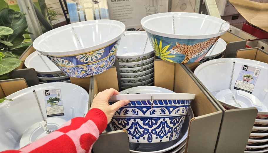 display of printed hanging flower planters in store