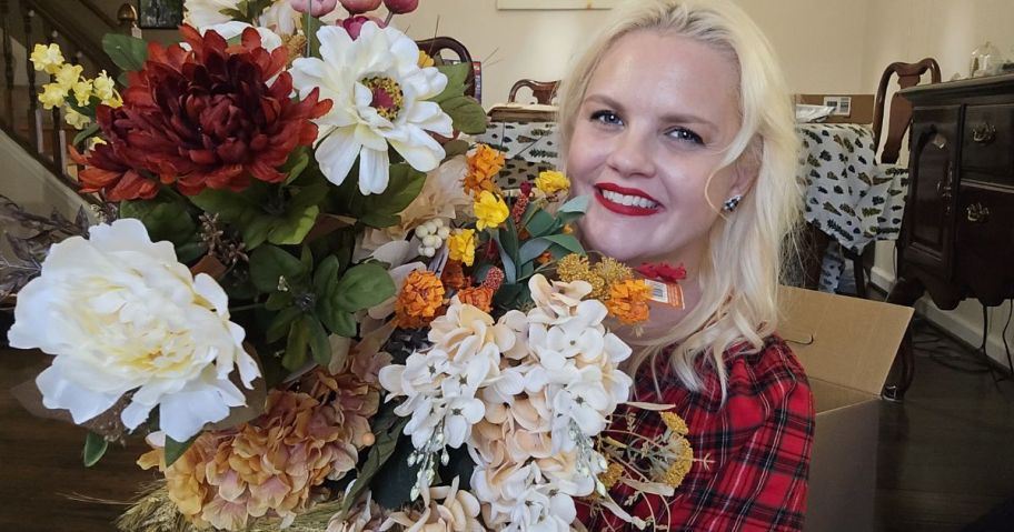 A woman holding floral arrangements 