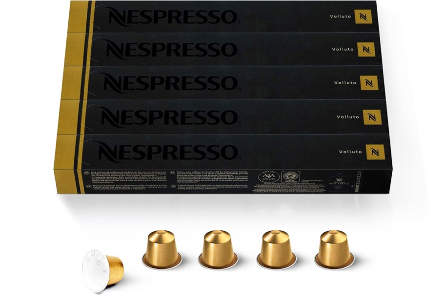 multiple boxes of gold Nespresso Pods