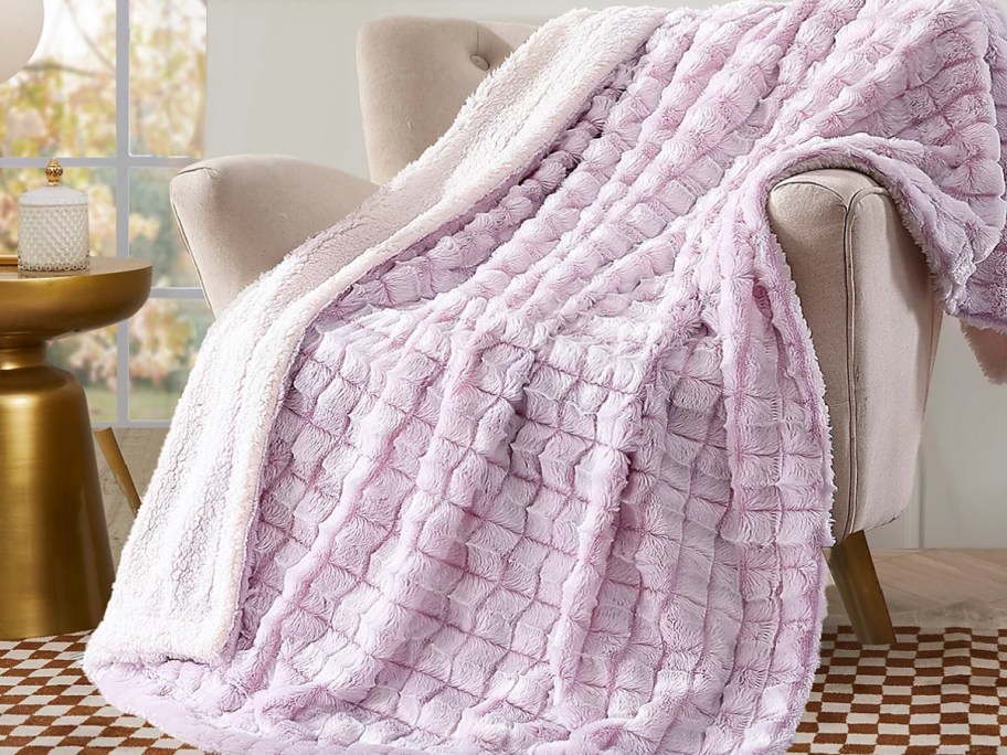 Pink throw blanket on a chair