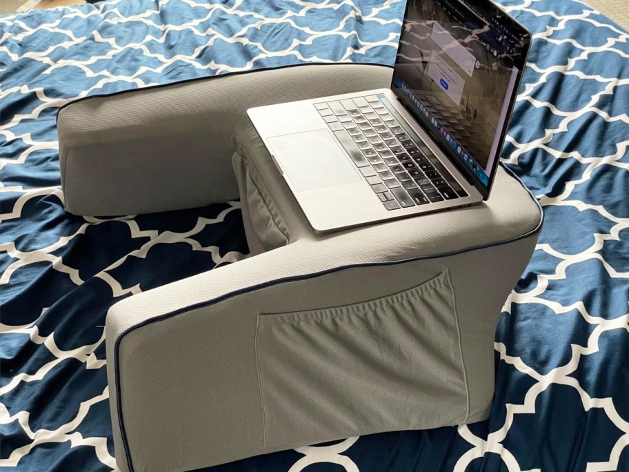 grey lap desk pillow on bed with laptop on top