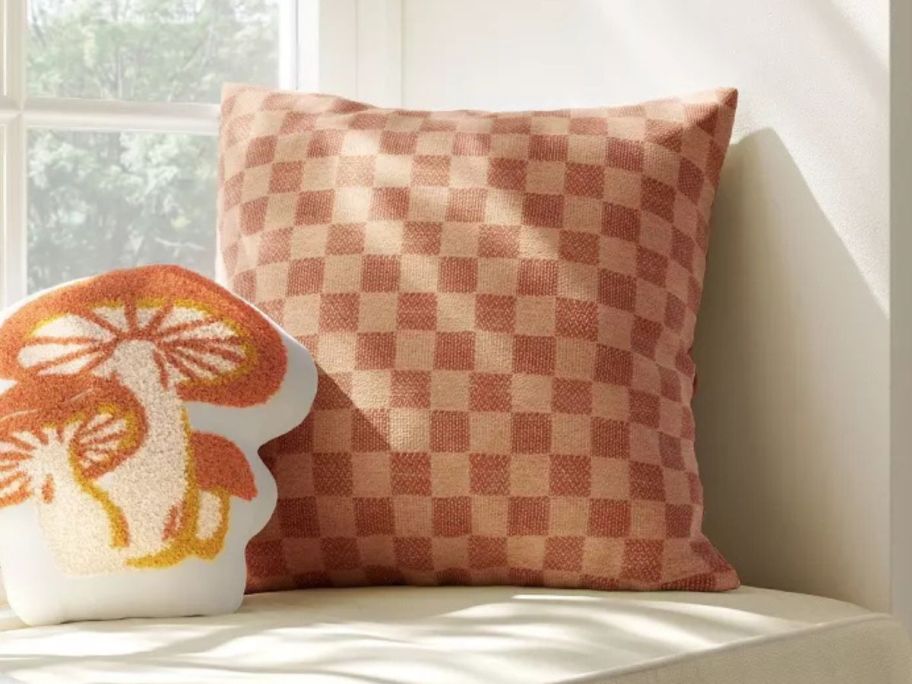 Room Essentials Checkerboard Woven Cotton Square Throw Pillow in Terracotta on bench