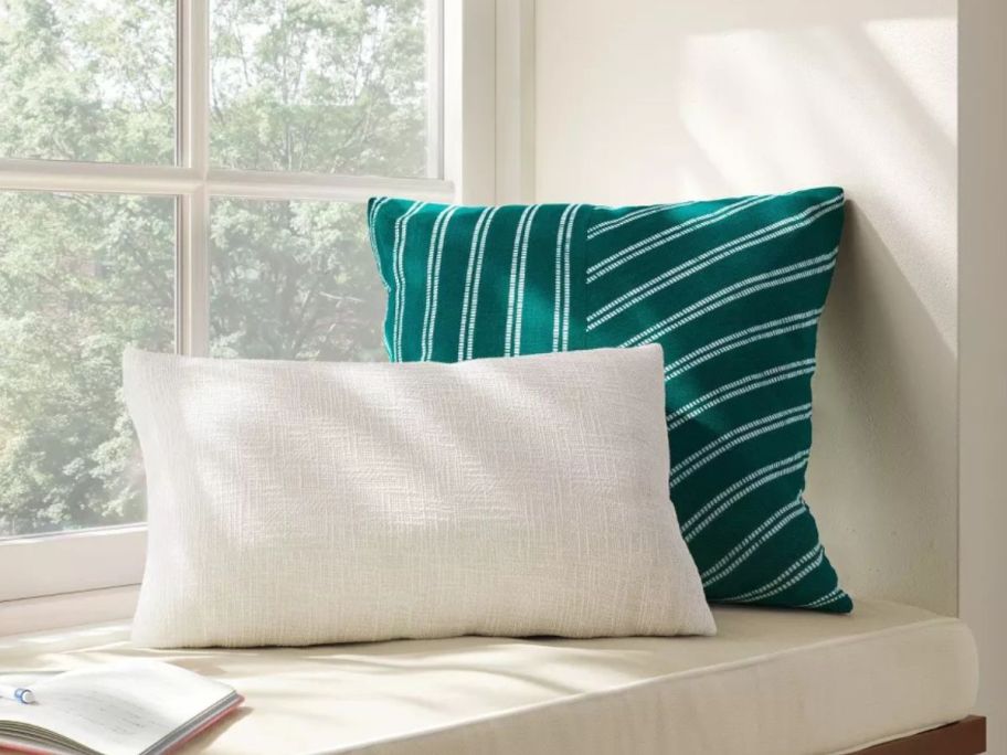 Room Essentials Square Pieced Angled Striped Woven Cotton Pillow on bench with pillow in front of it