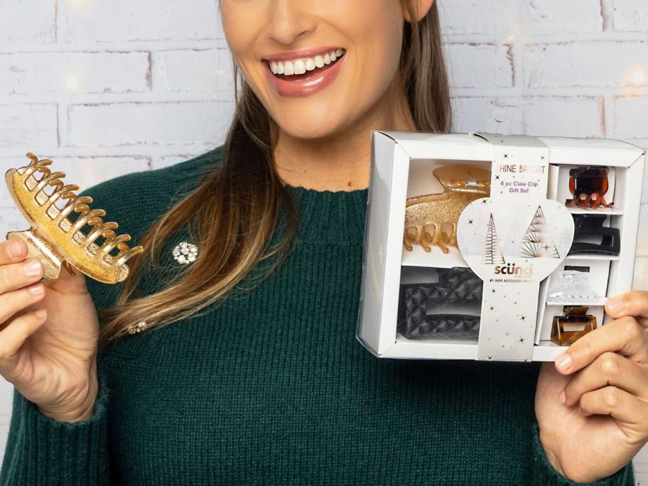 woman holding a A Scunci Holiday Gift Sets with claw clips