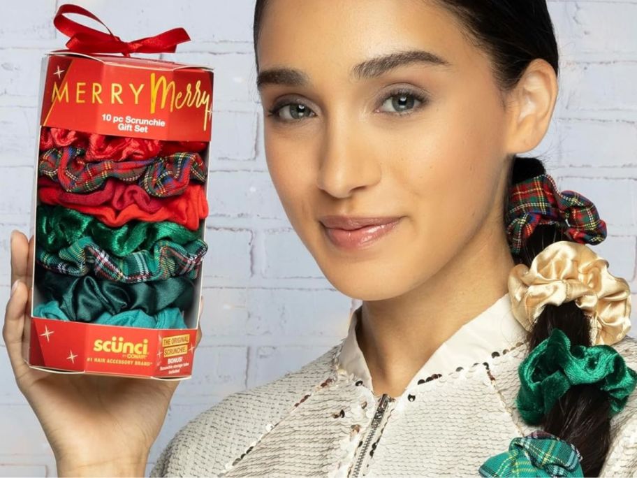 woman holding a 10-pack of holiday Scunci scrunchies