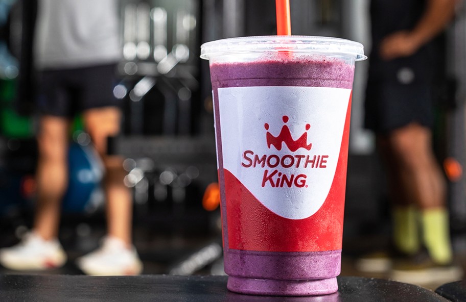 Smoothie King Almond Berry Smoothie sitting on gym bench