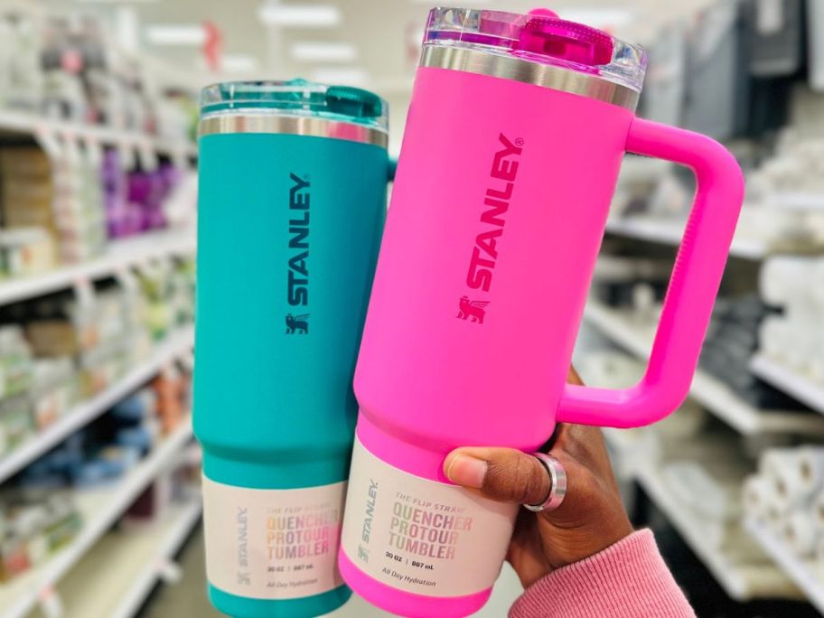 Hand holding up two Stanley 30oz Tumblers