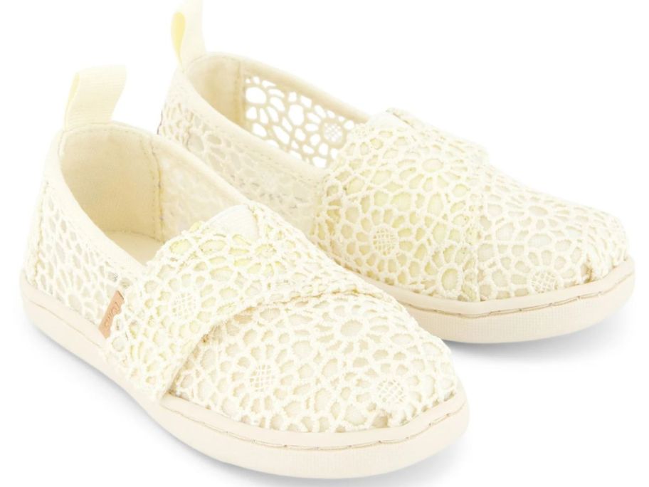 A pair of lace toddler TOMS shoes