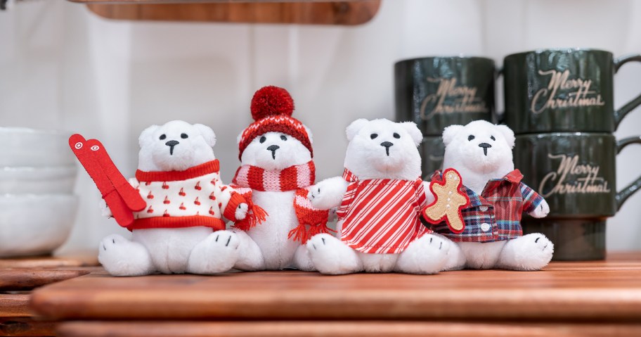 4 different white target holiday bears in christmas attire