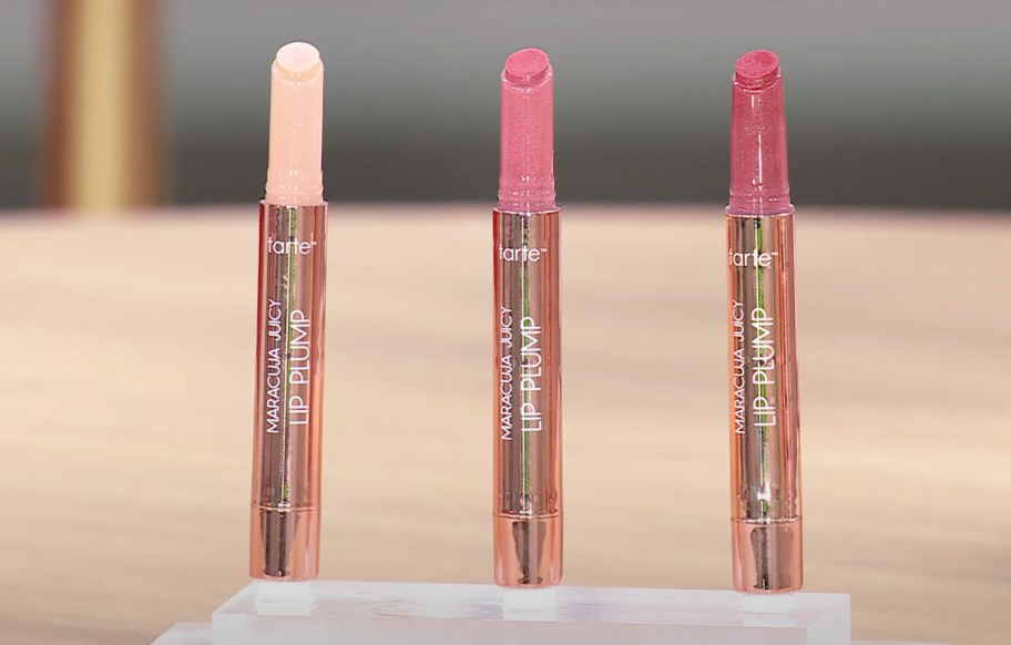 three opened tubes of Tarte Maracuja Juicy Lip Plump Shimmer