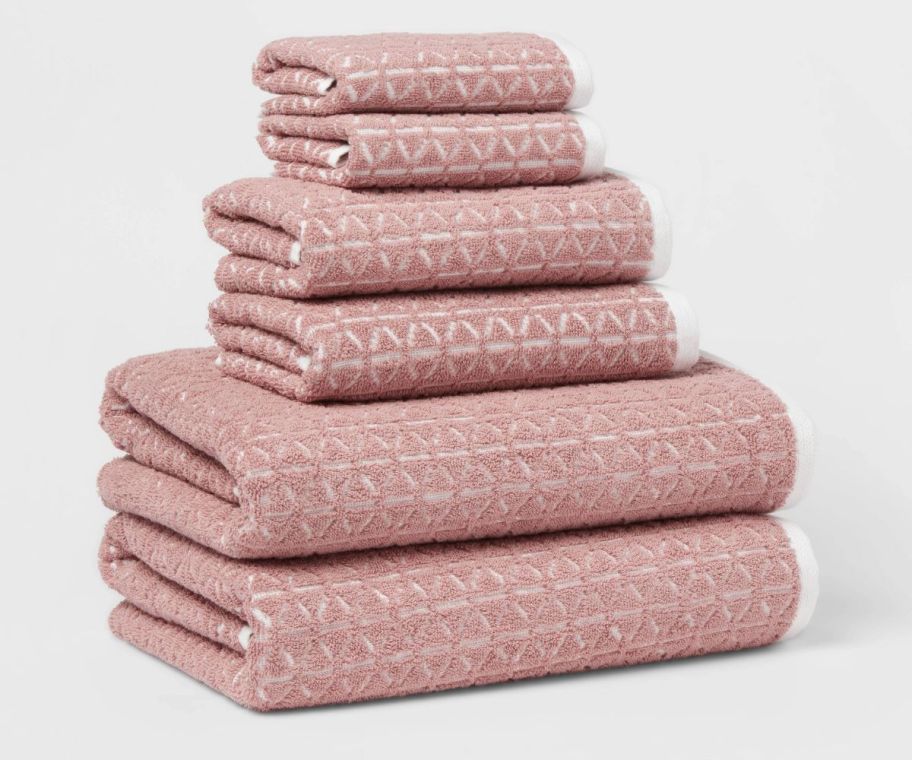 a stack of 6 mauve colored towels, hand towels and wash cloths