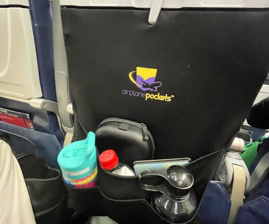 airplane pocket on an airplane seat full of drink containers