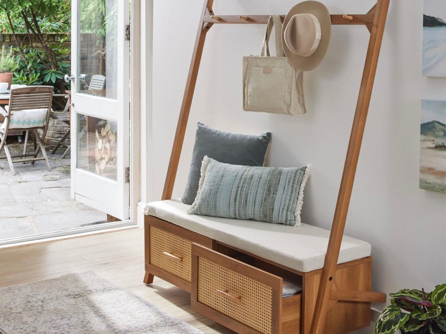 wooden hall tree with pillows and hat 