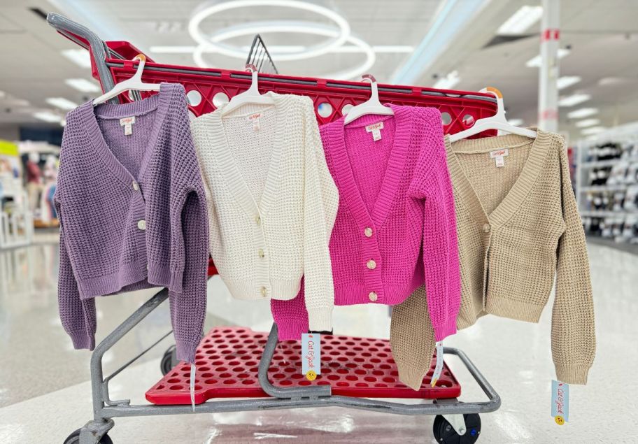 4 girls cardigans hanging on the side of a target shopping cart