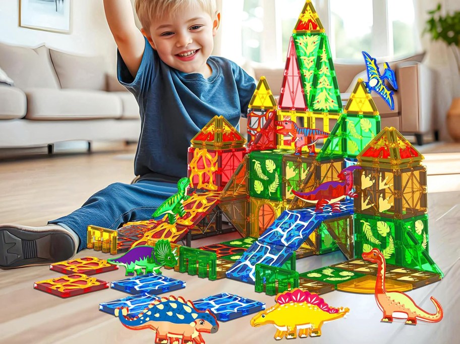 child playing with coodoo magnetic tiles on the floor