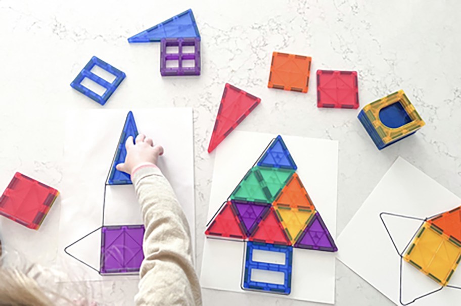 child playing with coodoo magnetic tiles