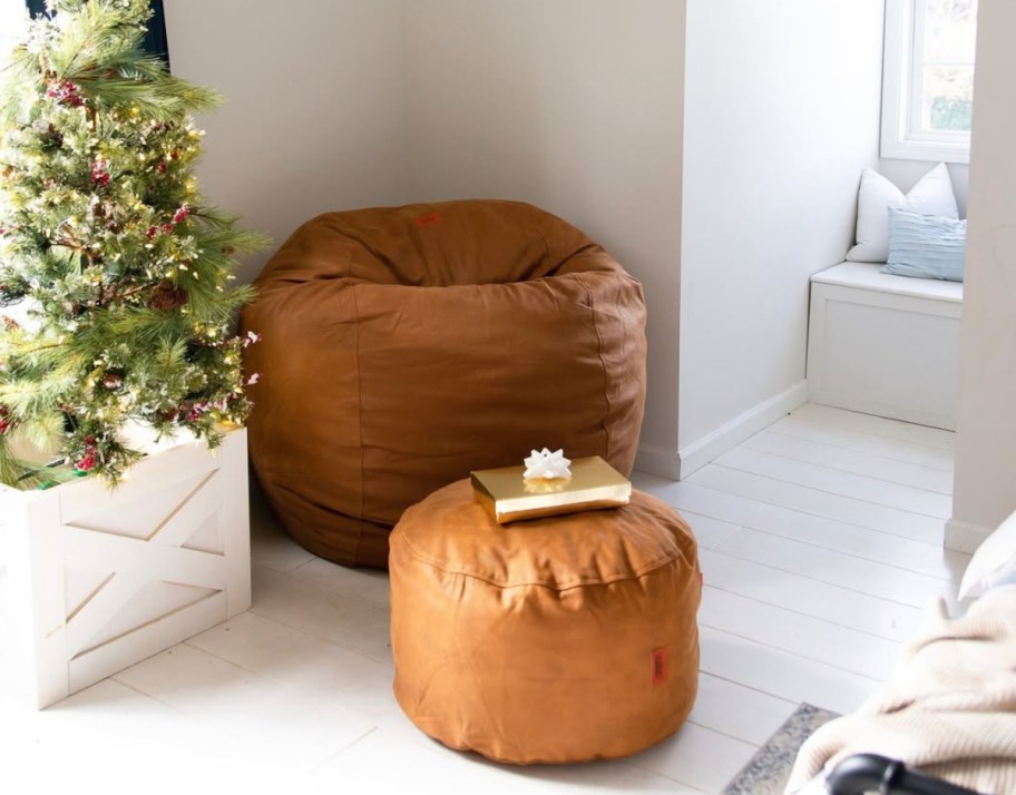 brown faux leather bean bag and ottoman in corner of loft room